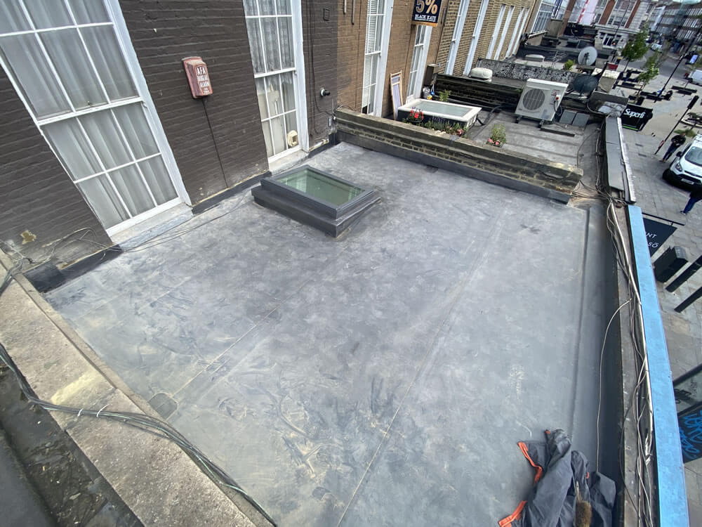 Flat roof stripped back for replacement in Camden