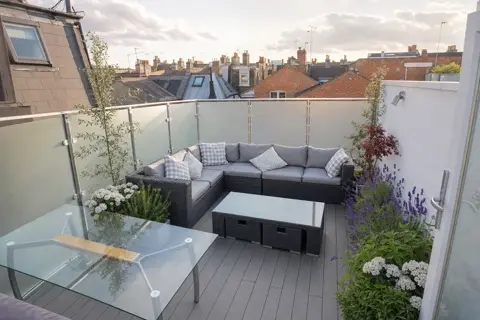 Roof terrace with seating, planting and glazed guarding