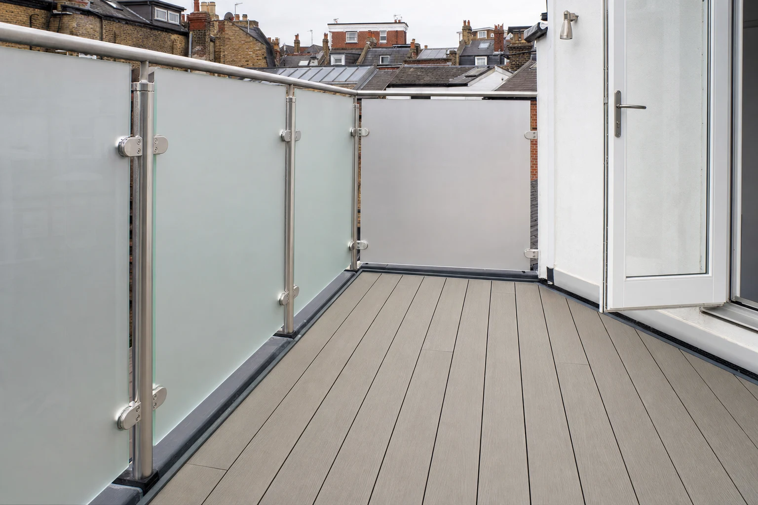 Roof terrace detail with glazed guarding, decking and doorway