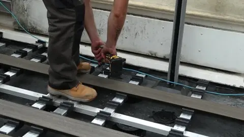Original Paddington project photograph showing composite deck boards being installed over the raised support system