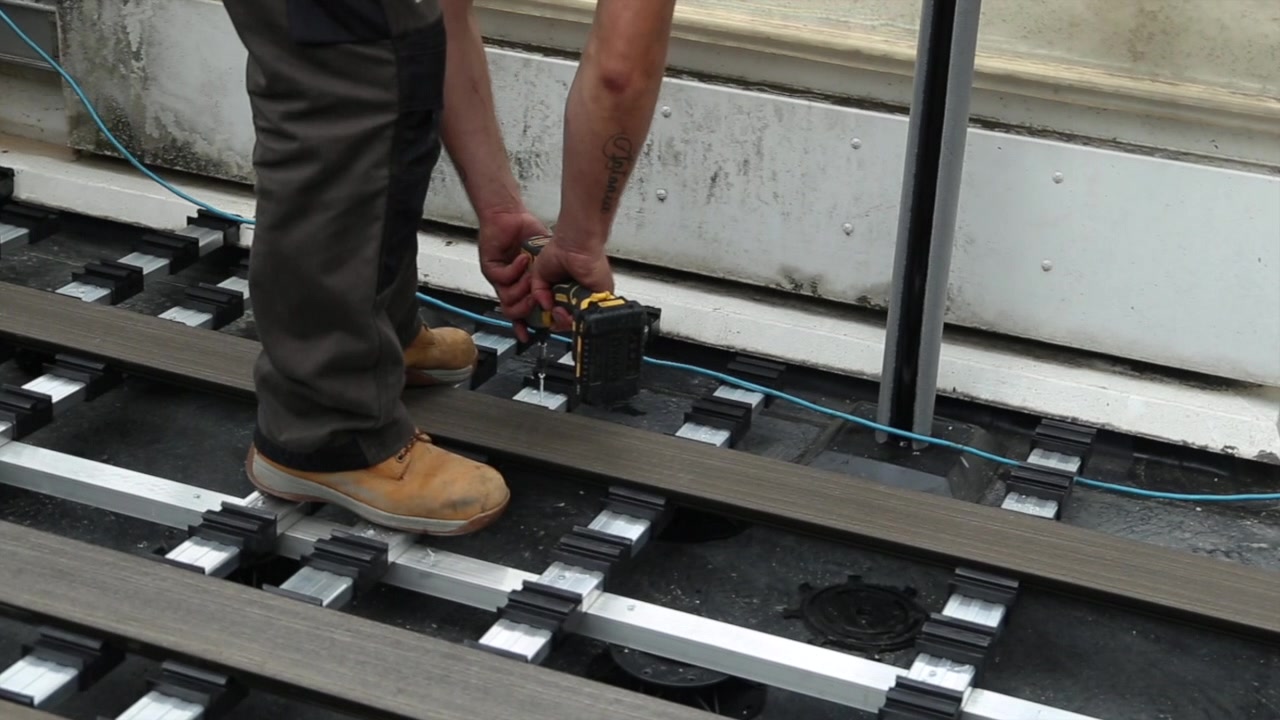 Deck boards being fixed over the raised support system on the Paddington roof terrace