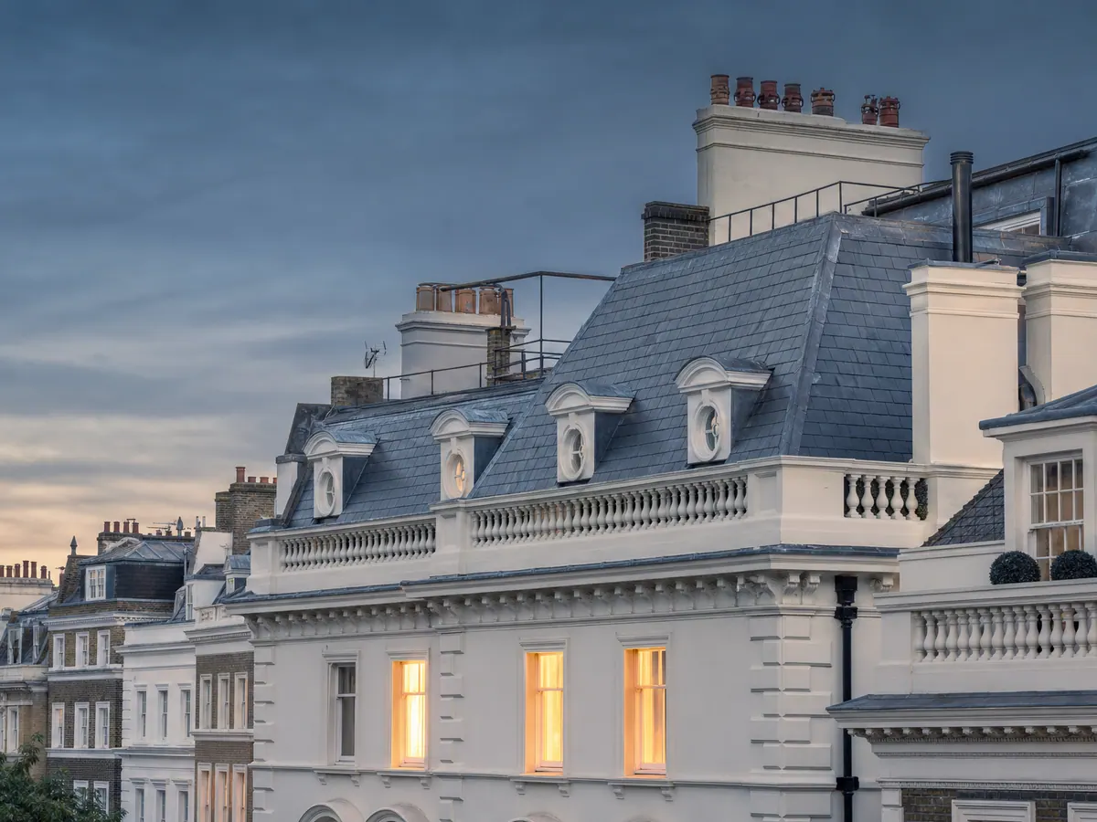 Slate roof and dormers on a period townhouse at dusk
