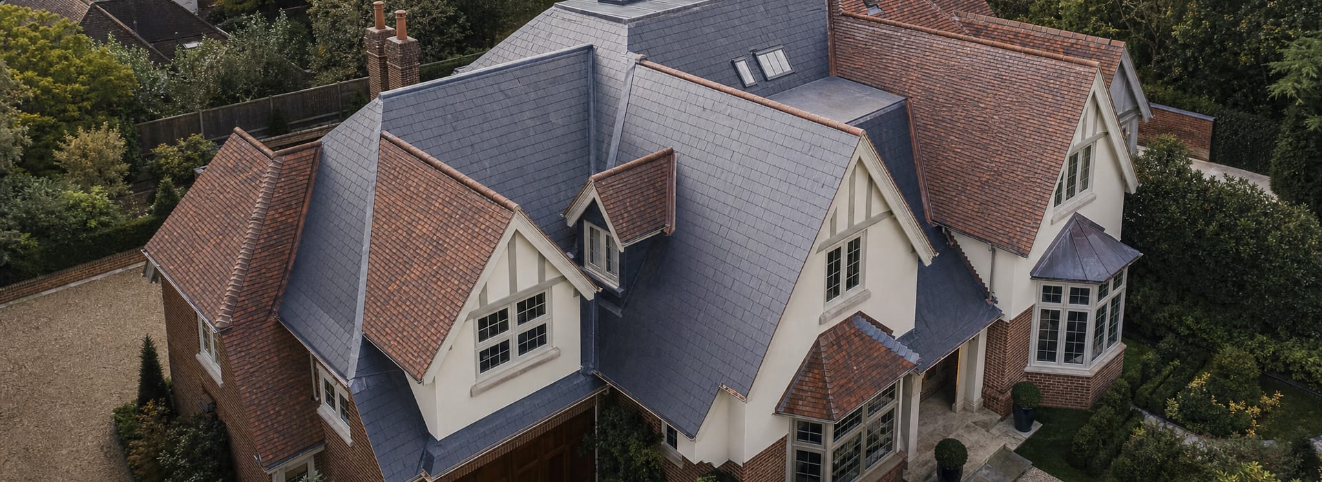 Roofing work across several roof areas on a substantial private home