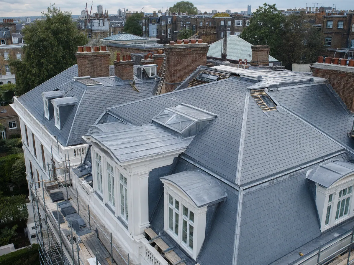 Slate roof, lead cappings and chimneys on a scaffolded period property