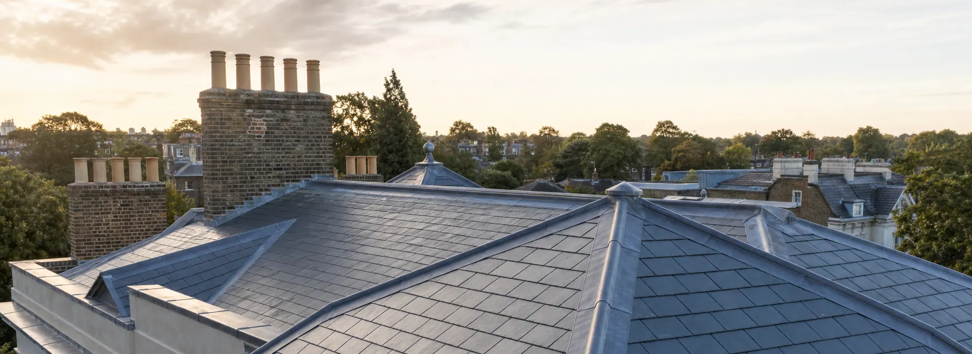 Natural slate roof with leaded hips and parapet cappings