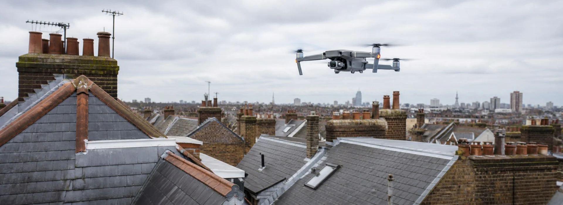 Illustrative drone flying above London residential roofs
