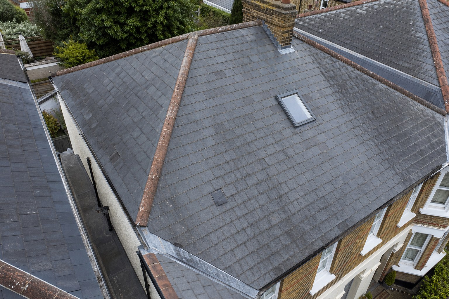 Illustrative aerial view of slate roof coverings and flashing details