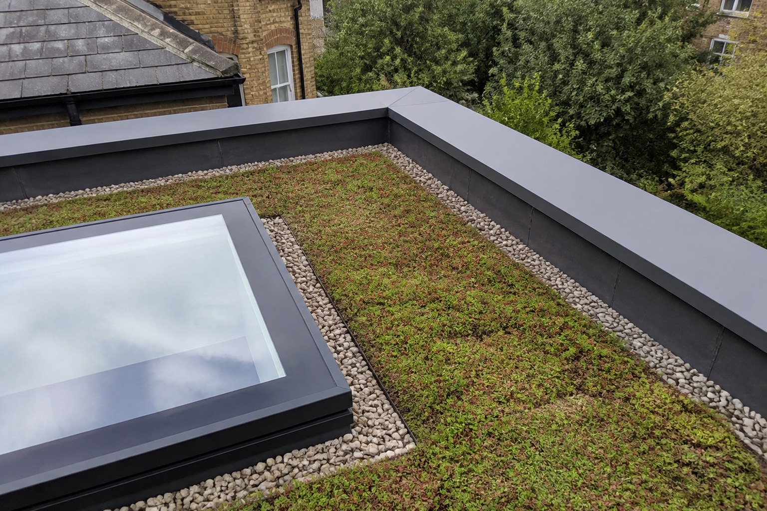 Illustrative green roof edges, parapet upstands and rooflight junction