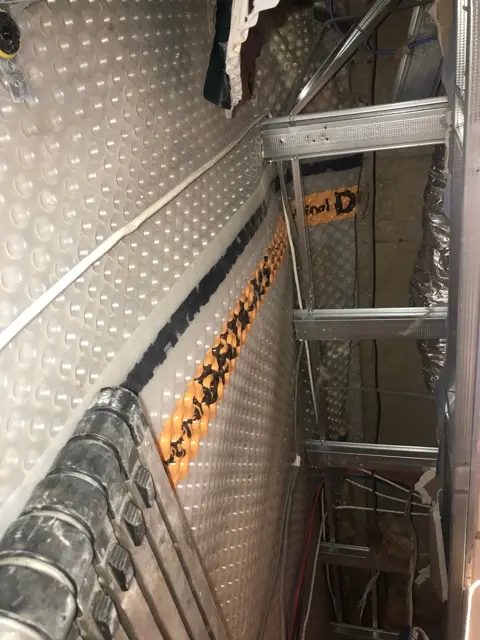 Basement tanking membrane and service routes during remedial work