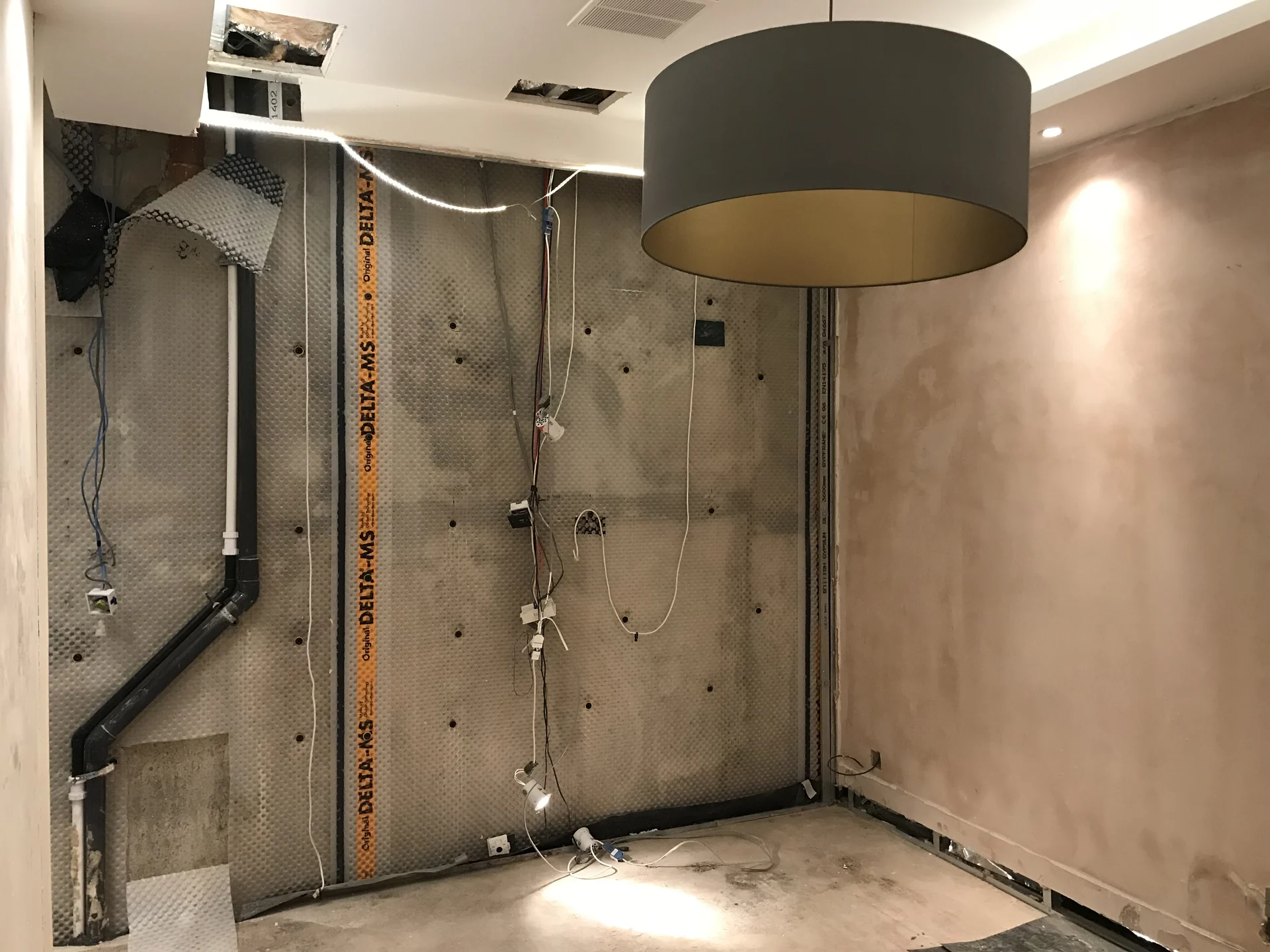 Basement wall opened for waterproofing and service coordination