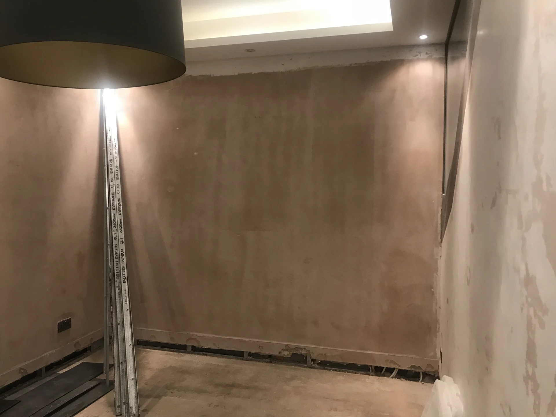 Basement wall opened to expose the waterproofing system