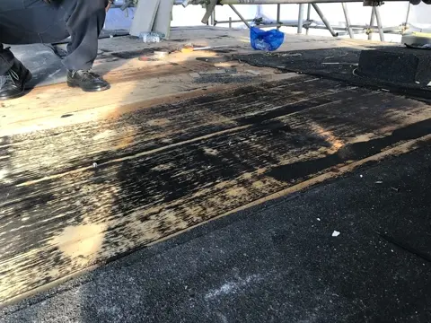 Main roof stripped back to the existing deck during repair works