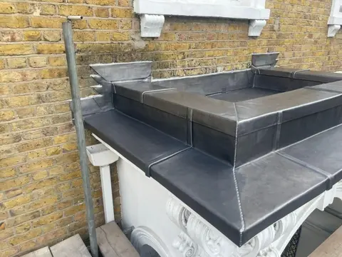 Lead capping formed around the Kensington parapet wall junction