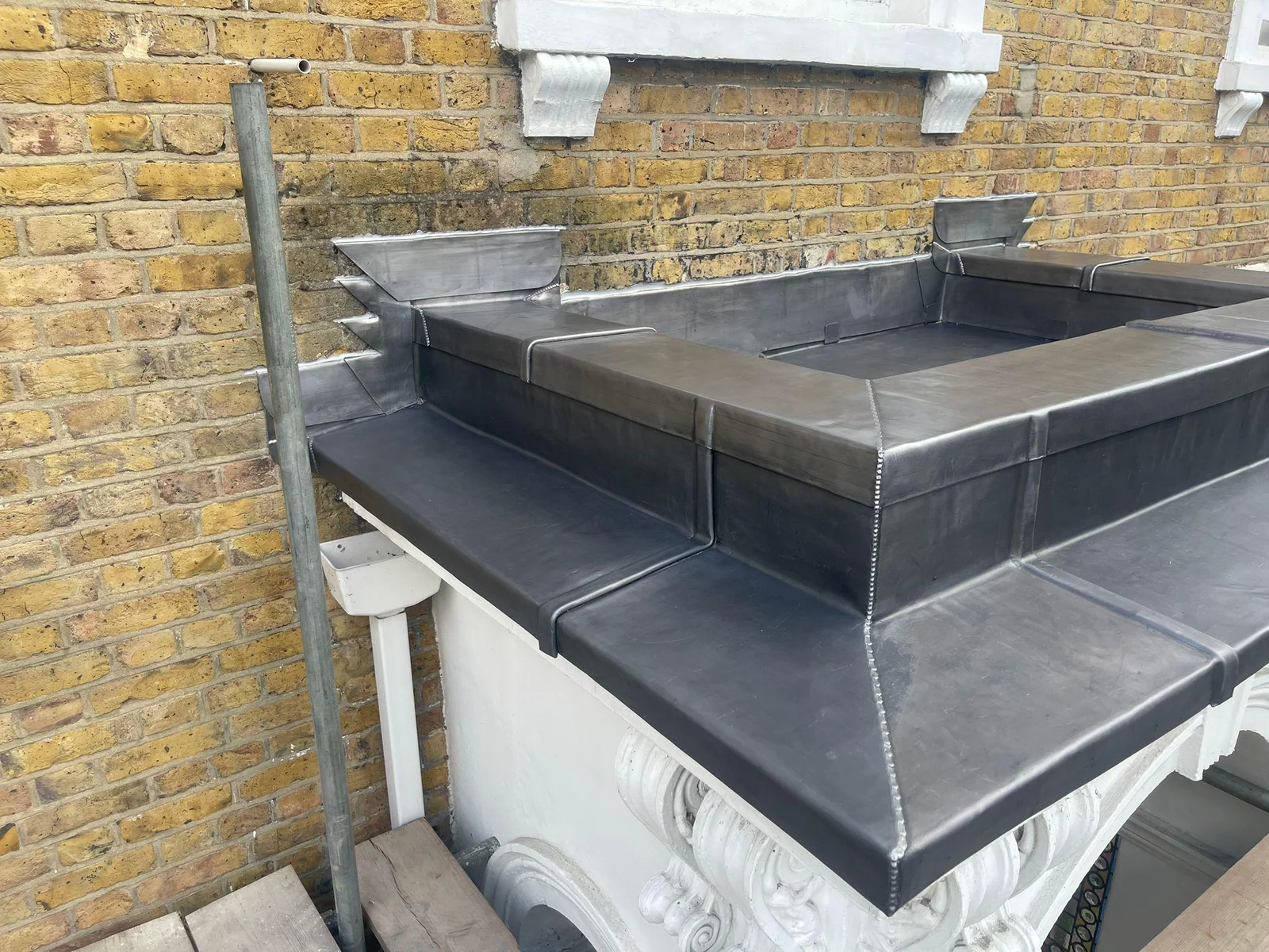 Lead capping formed around the Kensington parapet wall junction