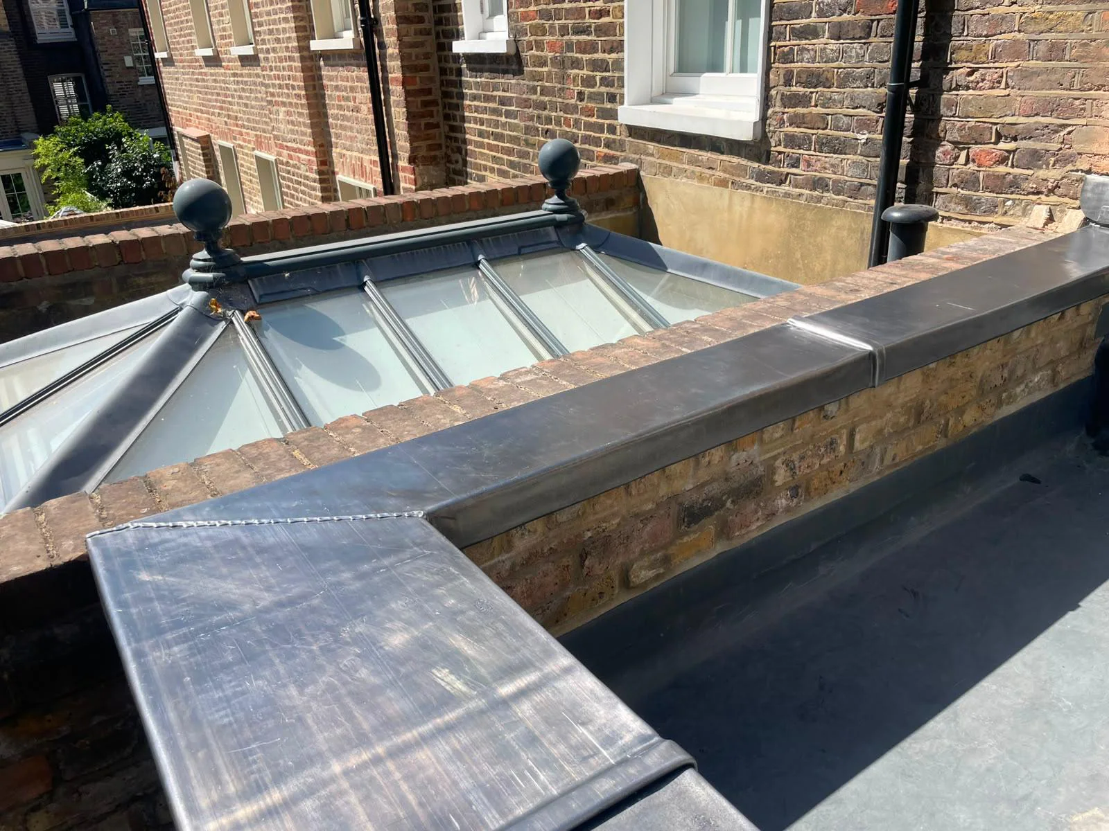Wide view of completed lead capping to the parapet wall
