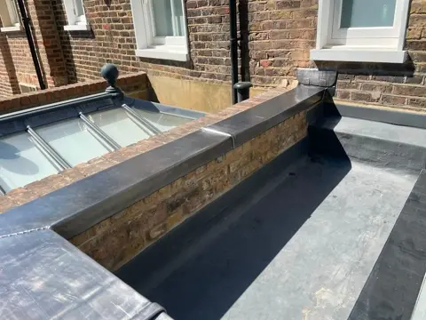 Lead weathering at the parapet and rooflight junction