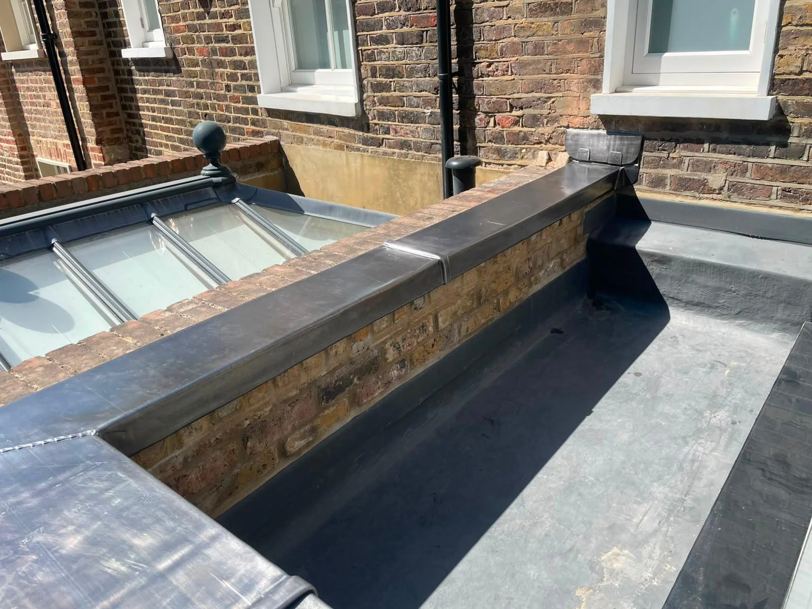Lead weathering at the parapet and rooflight junction