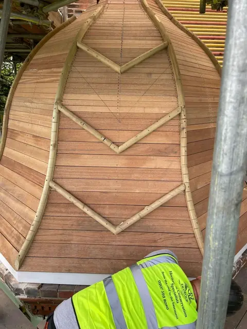 Curved timber battens formed around the turret roof