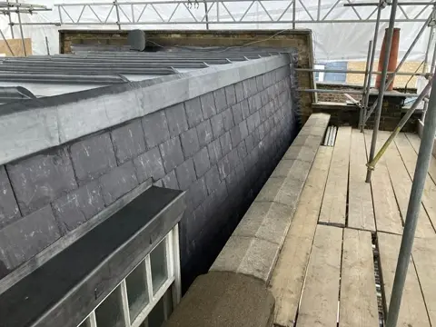 Completed junction between leadwork and slate roofing