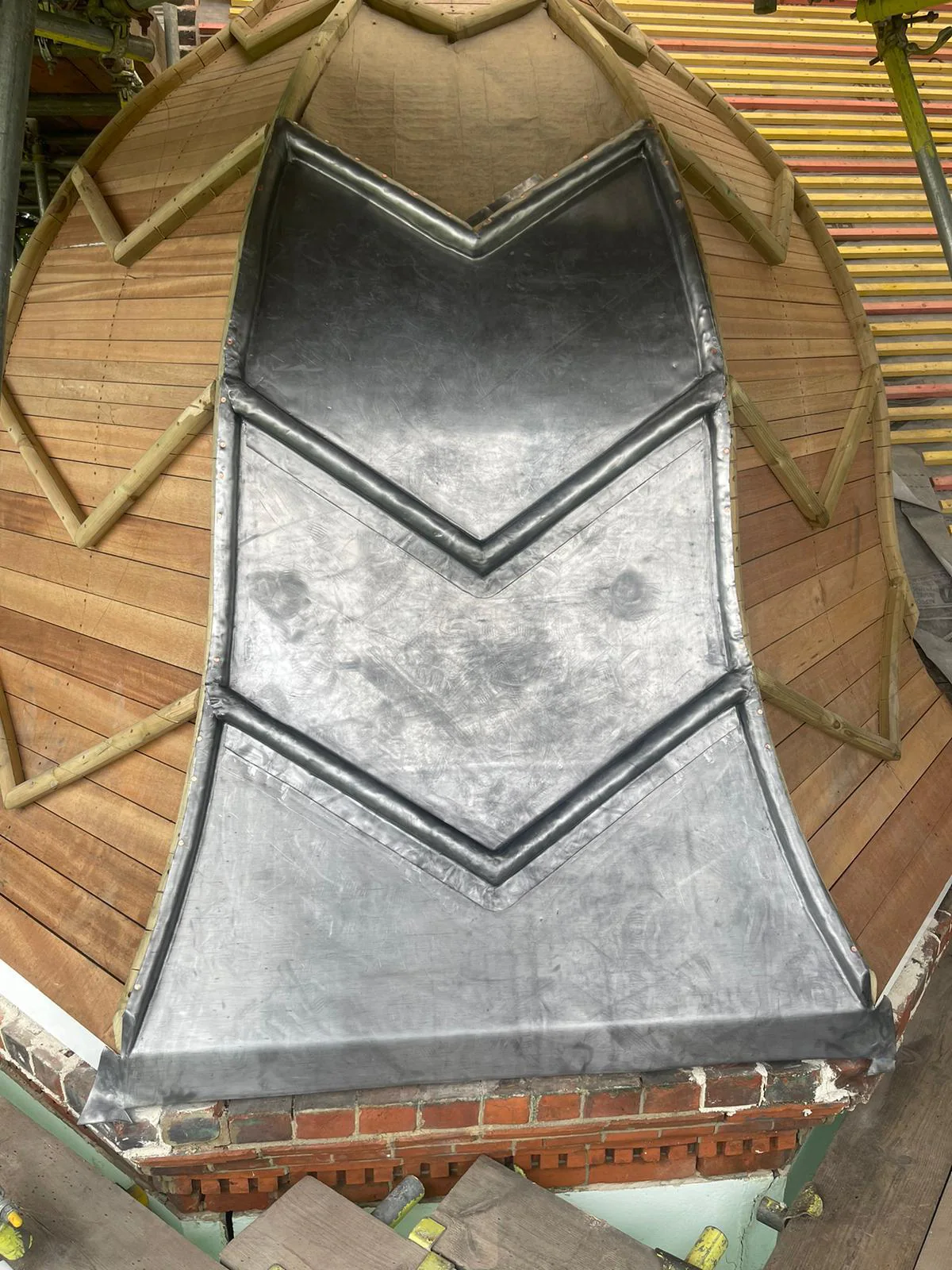 Timber framing at the base of the curved turret roof