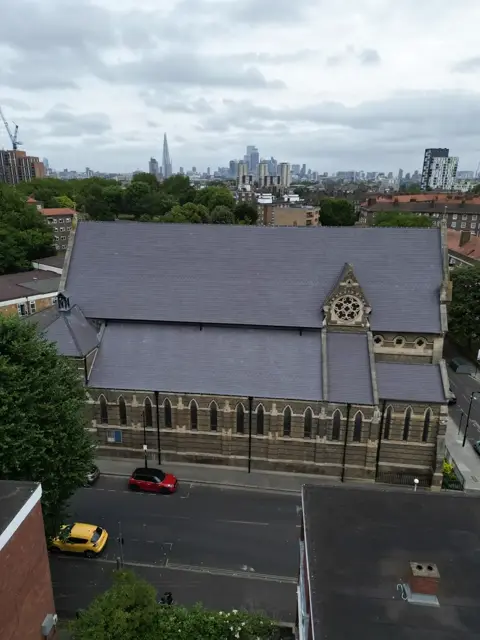 Aerial view along the side elevation of the church roof