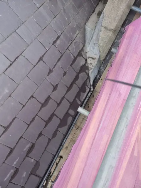Slate covering and drainage junction on the church roof