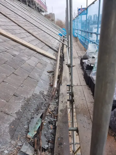 Slate renewal in progress across the church roof