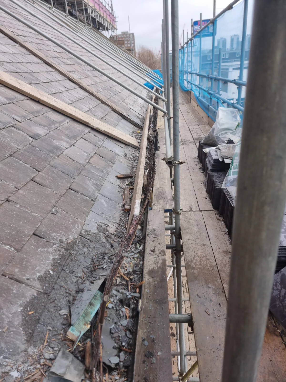 Slate renewal in progress across the church roof
