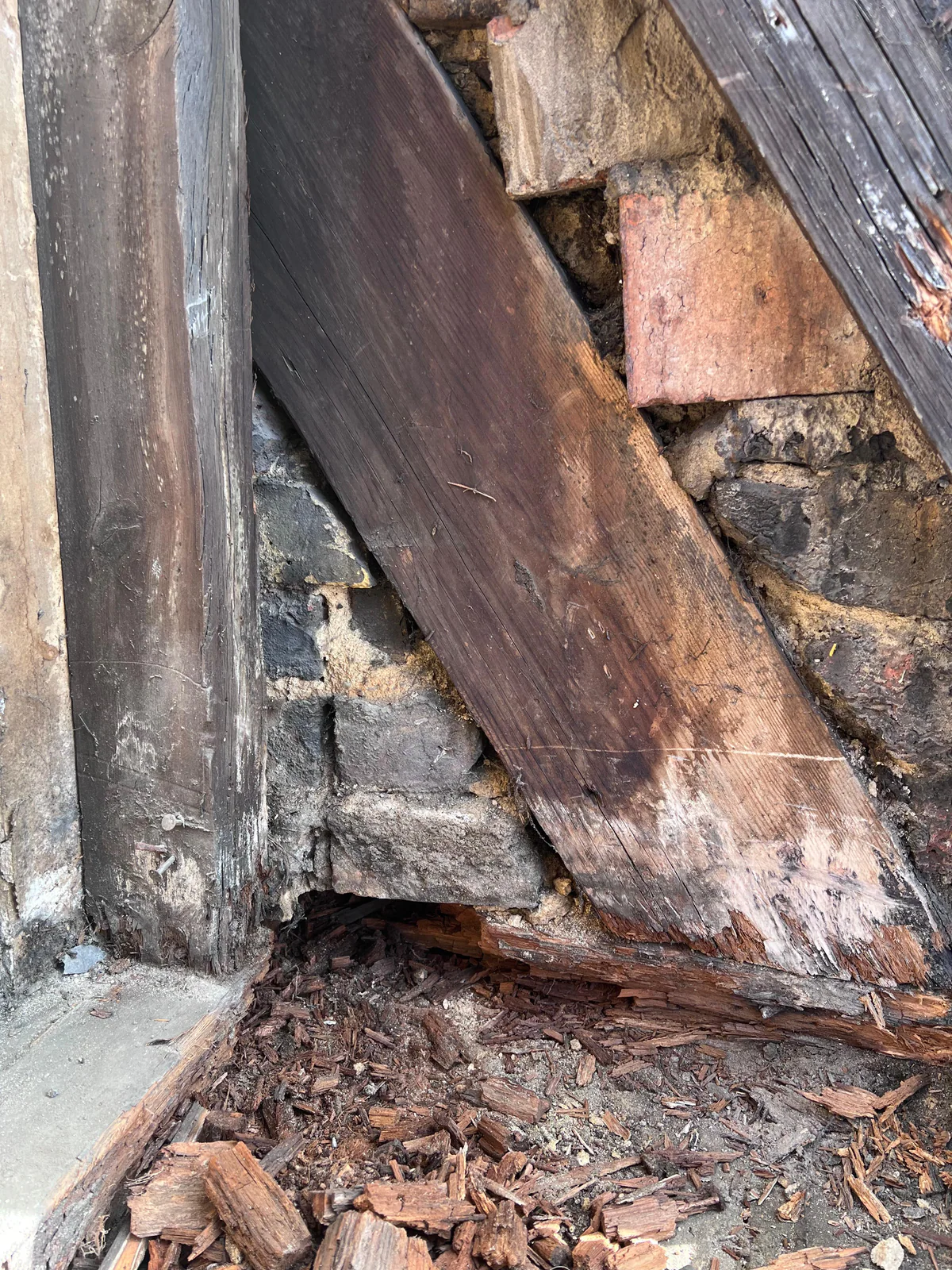 Exposed decayed timber within the church roof structure