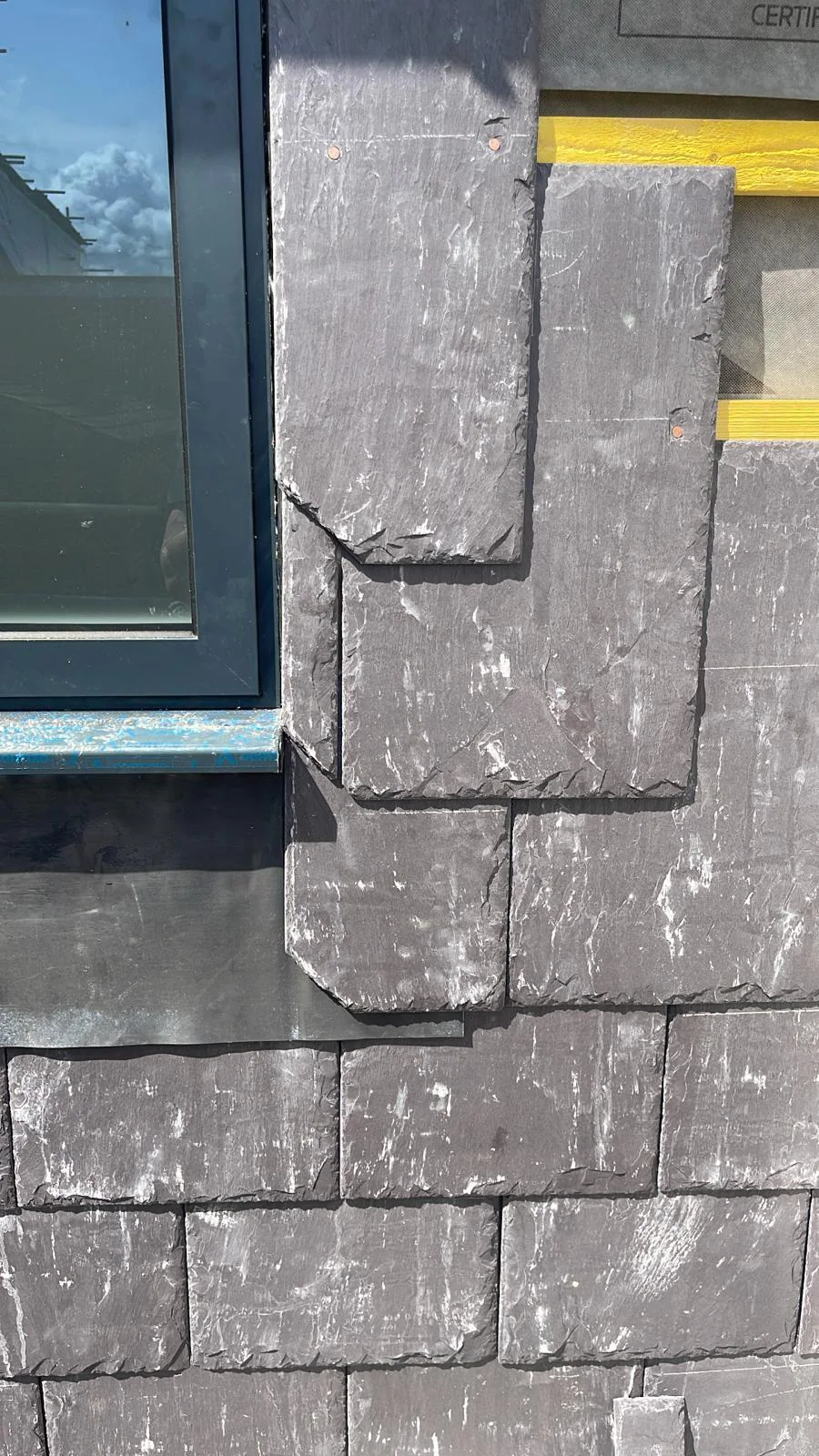 Close view of vertical slate detailing on the porch